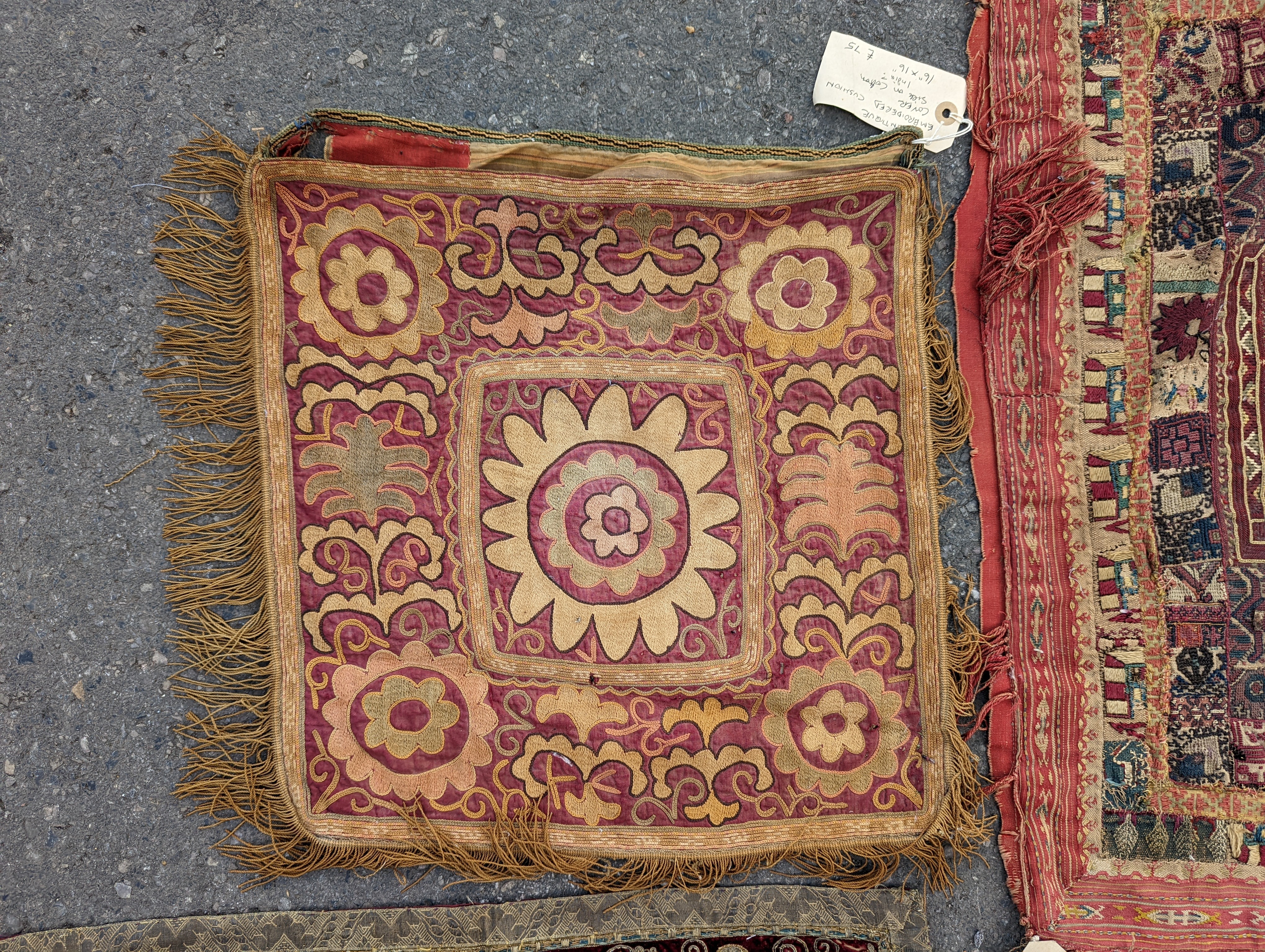 An Indian appliqué panel, two Indian appliqué covers and one other.